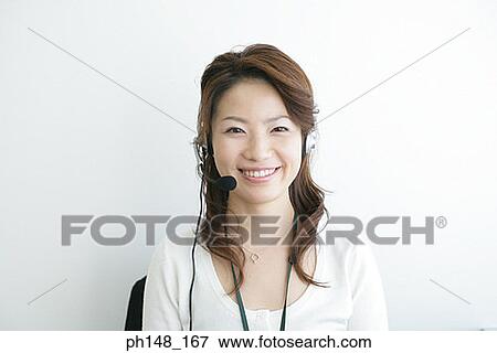Portrait of a businesswoman wearing a headset and looking cheerful View Large Photo Image Stock Photo - Portrait of a businesswoman wearing a headset and looking cheerful. Fotosearch