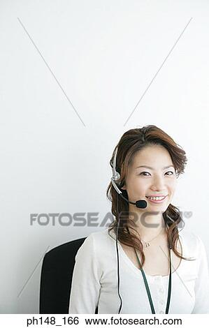 Portrait of a businesswoman wearing a headset and smiling View Large Photo Image Stock Photograph - Portrait of a businesswoman wearing a headset and smiling. Fotosearch