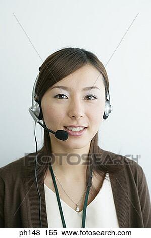 Portrait of a businesswoman wearing a headset and smiling View Large Photo Image Stock Photography - Portrait of a businesswoman wearing a headset and smiling. Fotosearch