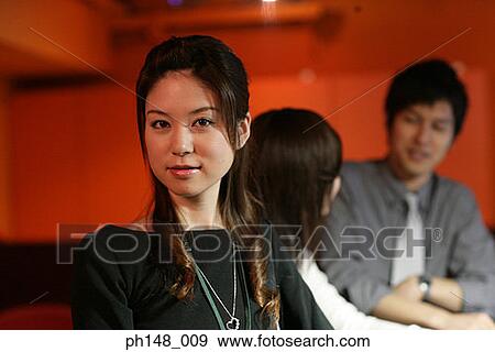 Portrait of a businesswoman with her two colleagues in the background View Large Photo Image Stock Photo - Portrait of a businesswoman with her two colleagues in the background. Fotosearch