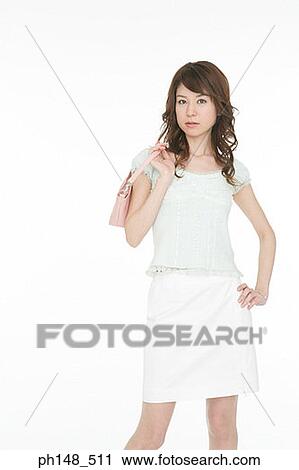 Portrait of a young woman carrying a purse View Large Photo Image Stock Image - Portrait of a young woman carrying a purse. Fotosearch