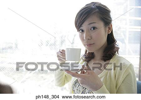 Portrait of a young woman drinking tea View Large Photo Image Picture - Portrait of a young woman drinking tea. Fotosearch