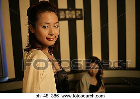 Portrait of a young woman grinning View Large Photo Image Stock Photograph - Portrait of a young woman grinning. Fotosearch