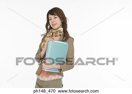 Portrait of a young woman holding a file View Large Photo Image Stock Image - Portrait of a young woman holding a file. Fotosearch
