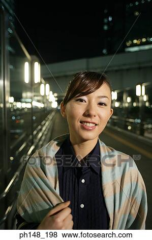 Portrait of a young woman smiling View Large Photo Image Stock Photo - Portrait of a young woman smiling. Fotosearch