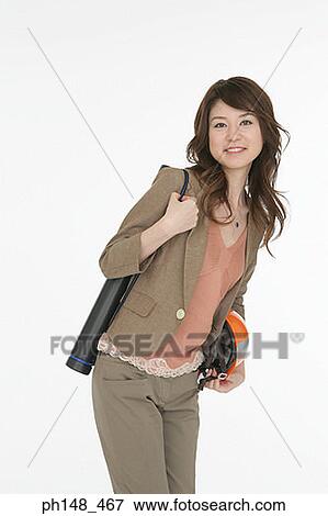 Stock Photo - Portrait of an architect holding a hard hat and carrying blueprints. Fotosearch