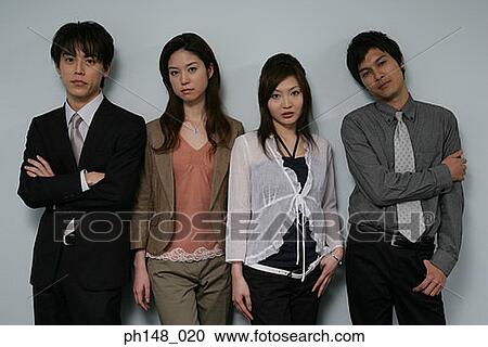Portrait of two businessmen and two businesswomen standing side by side View Large Photo Image Stock Image - Portrait of two businessmen and two businesswomen standing side by side. Fotosearch