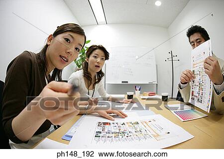 Portrait of two businesswomen and a businessman sitting in a conference room View Large Photo Image Stock Image - Portrait of two businesswomen and a businessman sitting in a conference room. Fotosearch