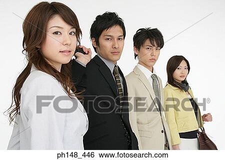 Stock Photograph - Portrait of two businesswomen and two businessmen standing in a row. Fotosearch