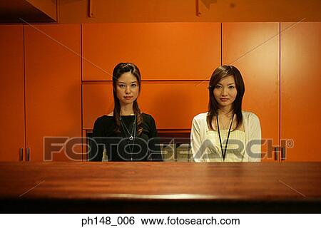 Portrait of two businesswomen in an office View Large Photo Image Stock Photograph - Portrait of two businesswomen in an office. Fotosearch