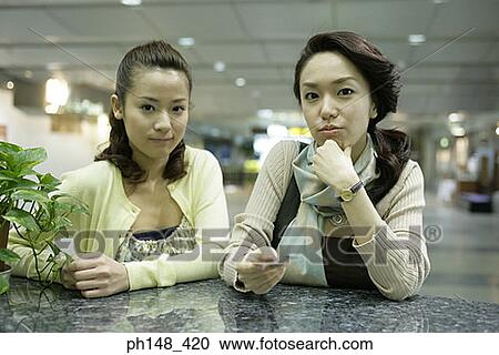 Portrait of two young women at a subway station View Large Photo Image Stock Image - Portrait of two young women at a subway station. Fotosearch