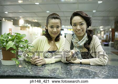 Portrait of two young women at a subway station View Large Photo Image Stock Image - Portrait of two young women at a subway station. Fotosearch