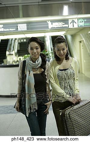 Portrait of two young women at a subway station View Large Photo Image Stock Image - Portrait of two young women at a subway station. Fotosearch