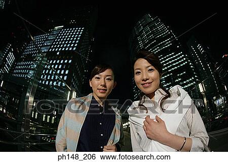 Stock Photograph - Portrait of two young women smiling. Fotosearch