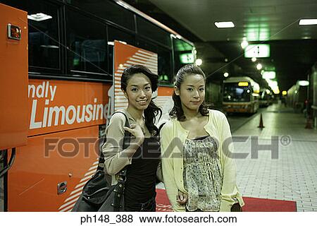 Portrait of two young women standing at a subway station View Large Photo Image Stock Photo - Portrait of two young women standing at a subway station. Fotosearch