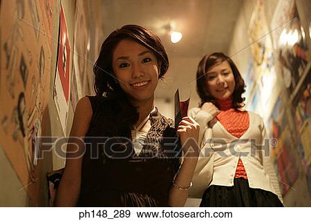 Portrait of two young women walking down stairs View Large Photo Image Stock Photo - Portrait of two young women walking down stairs. Fotosearch