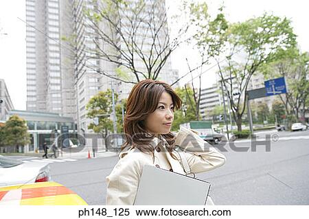Side profile of a young woman holding a file and looking away View Large Photo Image Stock Photography - Side profile of a young woman holding a file and looking away. Fotosearch