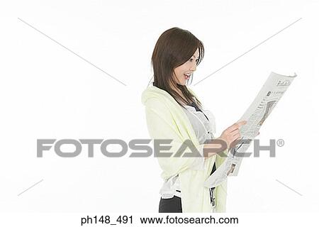 Side profile of a young woman reading a newspaper View Large Photo Image Stock Image - Side profile of a young woman reading a newspaper. Fotosearch