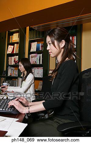 Side profile of two businesswomen working View Large Photo Image Stock Photo - Side profile of two businesswomen working. Fotosearch