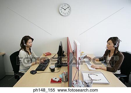 Side profile of two businesswomen wearing headsets and using computers View Large Photo Image Stock Photography - Side profile of two businesswomen wearing headsets and using computers. Fotosearch
