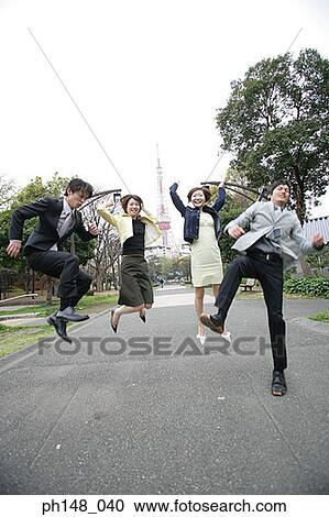 Two businessmen and two businesswomen jumping in a park View Large Photo Image Stock Image - Two businessmen and two businesswomen jumping in a park. Fotosearch