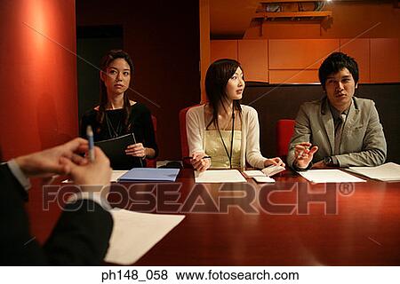 Two businessmen and two businesswomen in a meeting View Large Photo Image Stock Photo - Two businessmen and two businesswomen in a meeting. Fotosearch