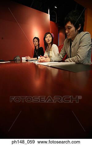 Two businesswomen and a businessman in a meeting View Large Photo Image Stock Photo - Two businesswomen and a businessman in a meeting. Fotosearch