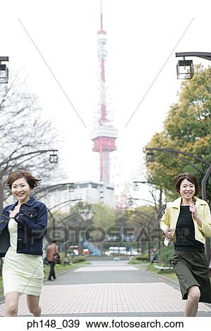 Two businesswomen running in a park and smiling View Large Photo Image Stock Photo - Two businesswomen running in a park and smiling. Fotosearch