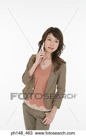 Stock Image - Young woman talking on a mobile phone. Fotosearch