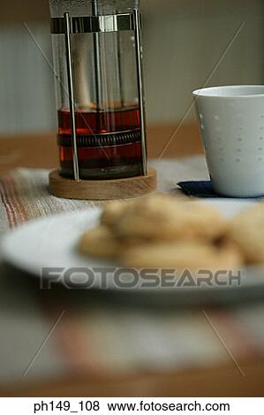 Close-up of a coffee maker with a cup and a plate of cookies on the table View Large Photo Image Stock Photo - Close-up of a coffee maker with a cup and a plate of cookies on the table. Fotosearch