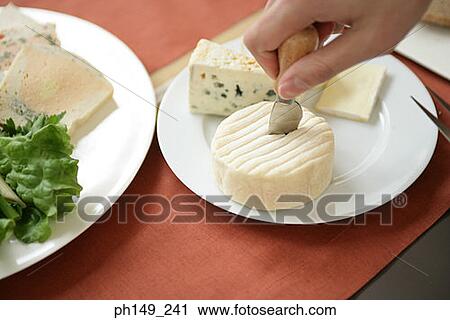 Close-up of a person cutting a slice of cheese View Large Photo Image Stock Image - Close-up of a person cutting a slice of cheese. Fotosearch