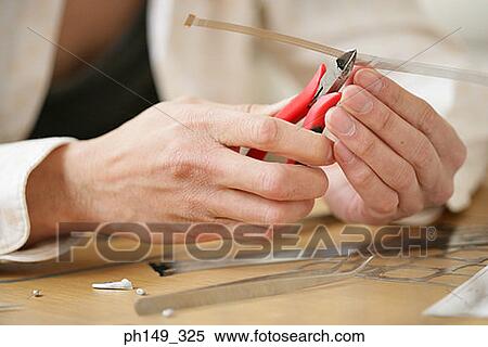 Close-up of a person's hand using a pair of pliers View Large Photo Image Stock Photography - Close-up of a person's hand using a pair of pliers. Fotosearch