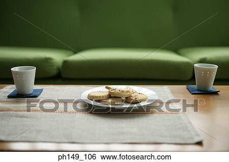 Close-up of a plate of cookies with two cups on the table View Large Photo Image Stock Photograph - Close-up of a plate of cookies with two cups on the table. Fotosearch