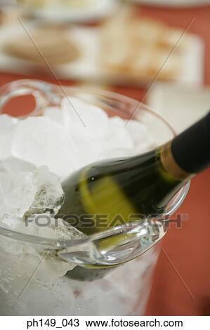 Close-up of a wine bottle in an ice bucket View Large Photo Image Stock Image - Close-up of a wine bottle in an ice bucket. Fotosearch