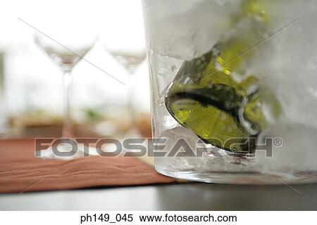 Stock Photography - Close-up of a wine bottle in an ice bucket. Fotosearch
