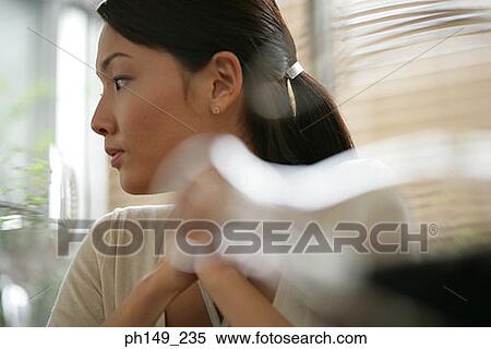 Close-up of a young woman looking sideways View Large Photo Image Stock Photography - Close-up of a young woman looking sideways. Fotosearch