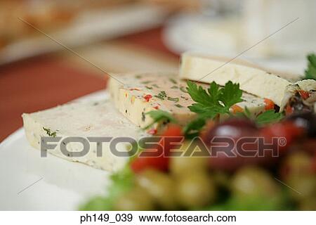 Stock Photo - Close-up of cheese slices in a plate. Fotosearch
