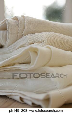 Close-up of folded curtains on the table View Large Photo Image Stock Photo - Close-up of folded curtains on the table. Fotosearch