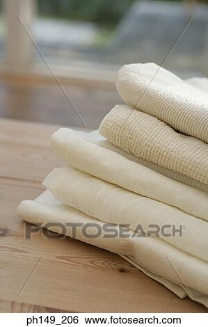 Close-up of folded curtains on the table View Large Photo Image Stock Photograph - Close-up of folded curtains on the table. Fotosearch