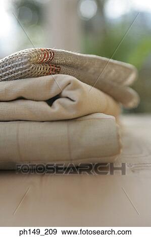 Close-up of folded fabrics on the table View Large Photo Image Stock Photo - Close-up of folded fabrics on the table. Fotosearch