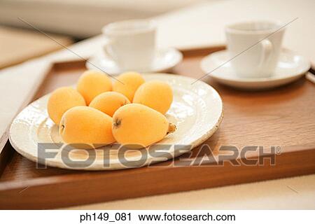 Close-up of loquats in a plate View Large Photo Image Stock Image - Close-up of loquats in a plate. Fotosearch