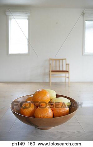 Stock Image - Close-up of oranges and mangoes in a fruit bowl. Fotosearch