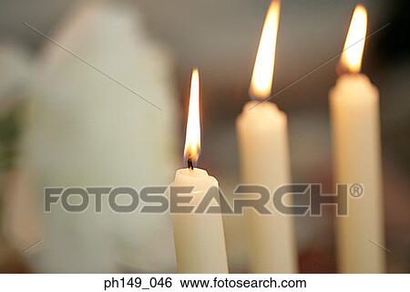 Close-up of three lit candles View Large Photo Image Stock Photograph - Close-up of three lit candles. Fotosearch