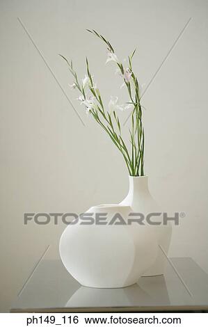 Close-up of white lilies in a flower vase View Large Photo Image Stock Photograph - Close-up of white lilies in a flower vase. Fotosearch