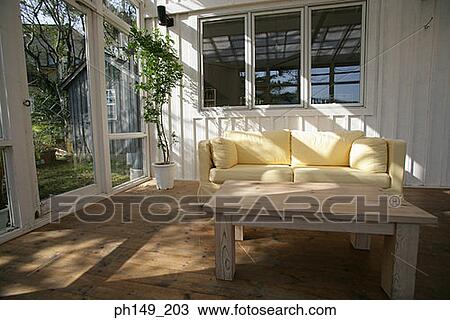 Stock Image - Empty couch with a table in a room. Fotosearch