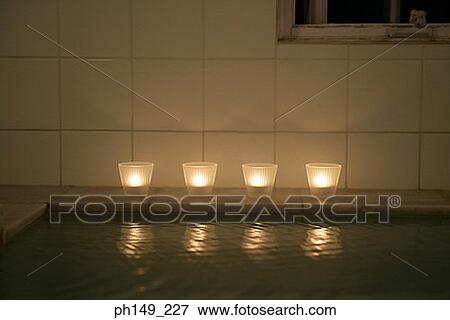 Four candles on the side of a bathtub View Large Photo Image Stock Photo - Four candles on the side of a bathtub. Fotosearch