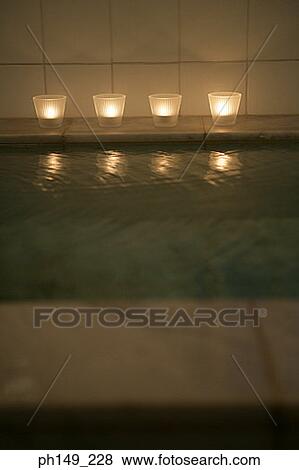 Four candles on the side of a bathtub View Large Photo Image Stock Photo - Four candles on the side of a bathtub. Fotosearch