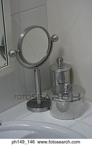 High angle view of a mirror with two containers near a bathroom sink View Large Photo Image Stock Photograph - High angle view of a mirror with two containers near a bathroom sink. Fotosearch