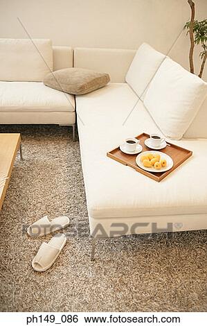 High angle view of a tray with cups of tea and loquats on a couch View Large Photo Image Stock Photograph - High angle view of a tray with cups of tea and loquats on a couch. Fotosearch