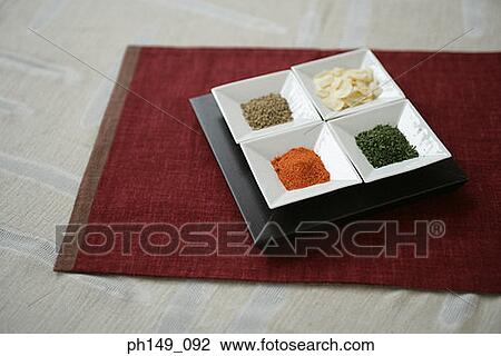 Stock Image - High angle view of assorted spices on a tray. Fotosearch